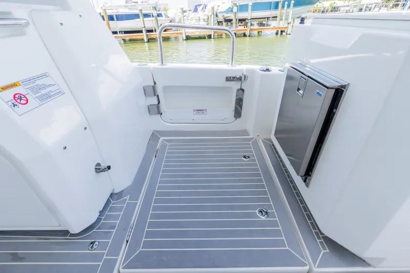 Slide: The Image of Aquila 36 Sport 2023 boat deck with storage and safety warning. - 16