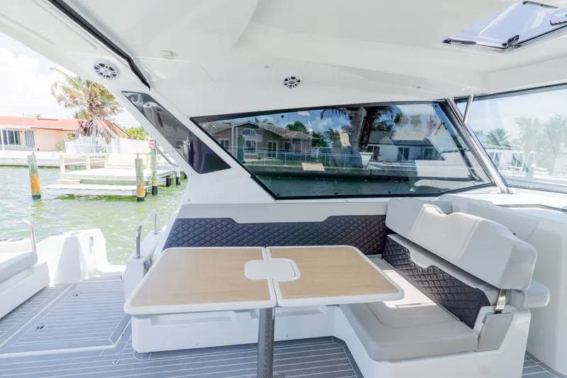 Slide: The Image of Interior of 2023 Aquila 36 Sport with seating area and table. - 17