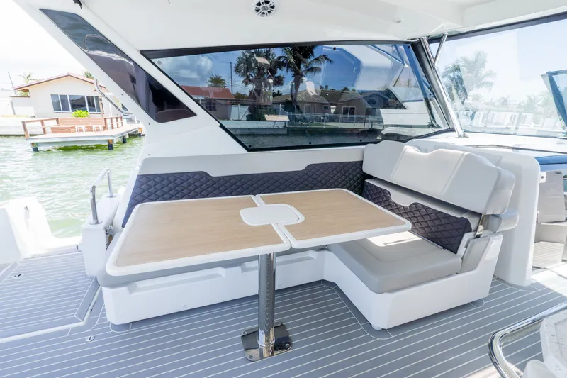 Slide: The Image of Interior of 2023 Aquila 36 Sport with seating area and table. - 18