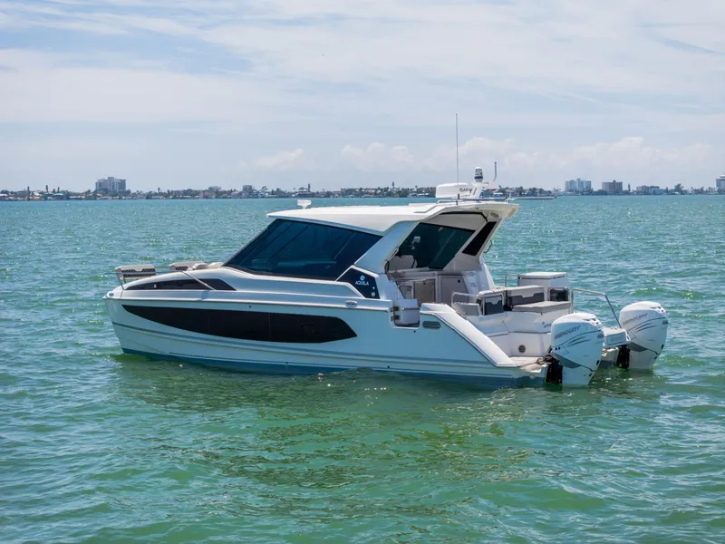 Slide: The Image of Aquila 36 Sport 2023 motorboat on calm waters. - 2