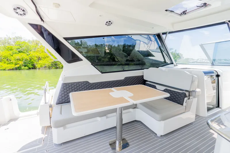Slide: The Image of Interior of 2023 Aquila 36 Sport with seating area and table. - 20