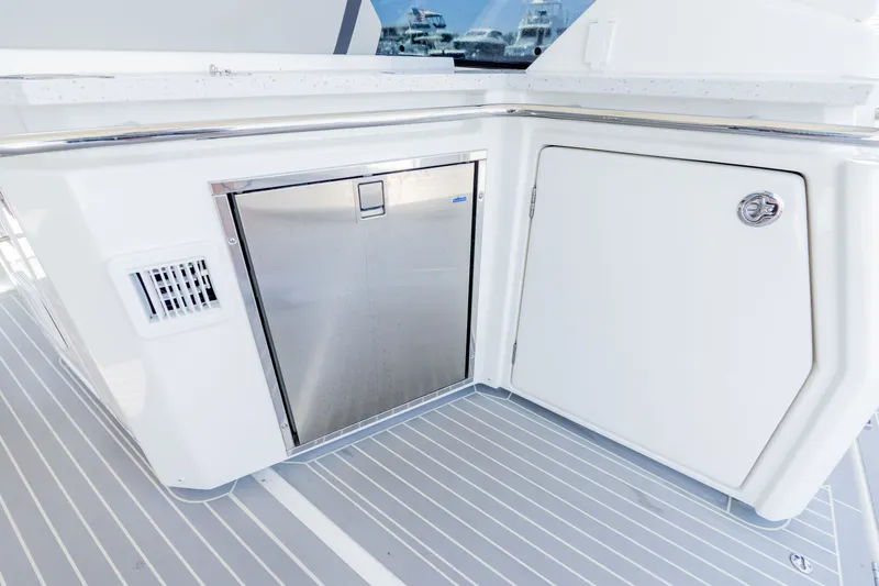 Slide: The Image of Aquila 36 Sport 2023 yacht kitchenette with stainless steel fridge. - 22