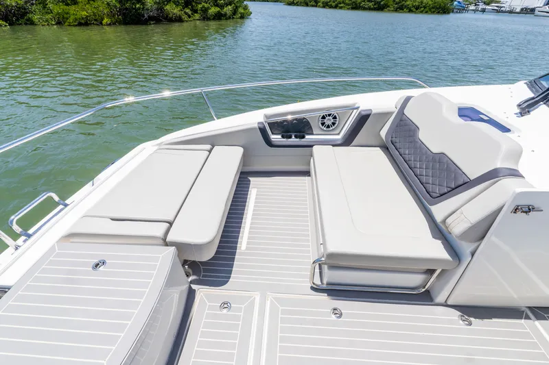 Slide: The Image of Aquila 36 Sport 2023: Luxurious boat seating by the water. - 30