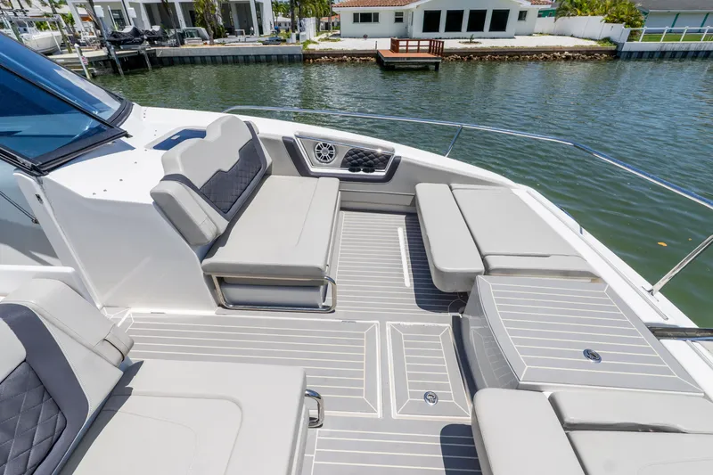 Slide: The Image of Aquila 36 Sport 2023 with luxurious deck and seating area by the water. - 31