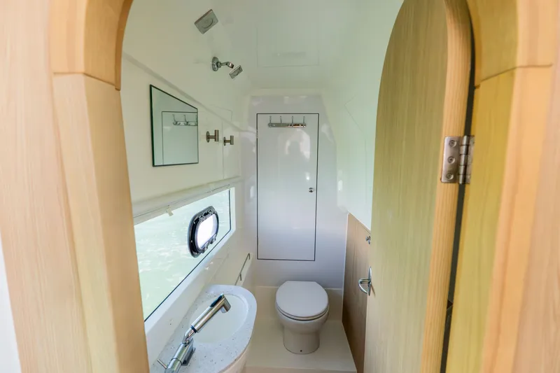 Slide: The Image of Interior of 2023 Aquila 36 Sport featuring toilet and sink. - 40