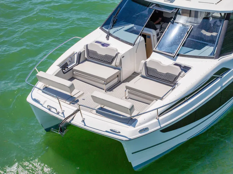 Slide: The Image of Aquila 36 Sport 2023 on green water, luxurious deck design. - 5