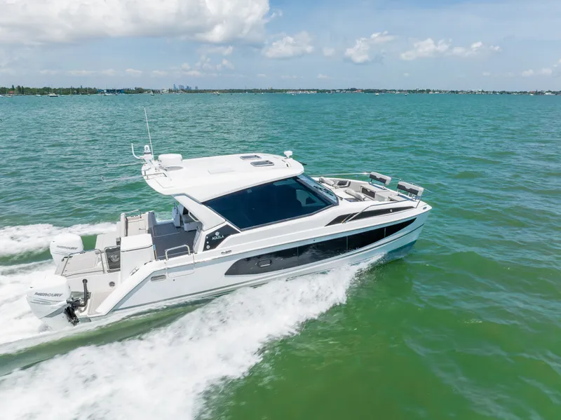 Slide: The Image of Aquila 36 Sport 2023 cruising on open sea under sunny skies. - 6
