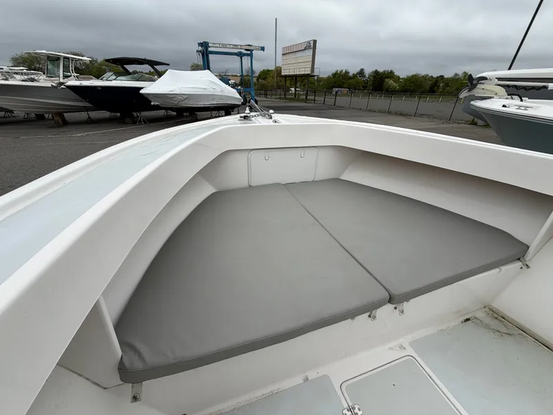 Slide: The Image of NorthCoast 230 CC 2022 boat with gray cushions at the dock. - 17