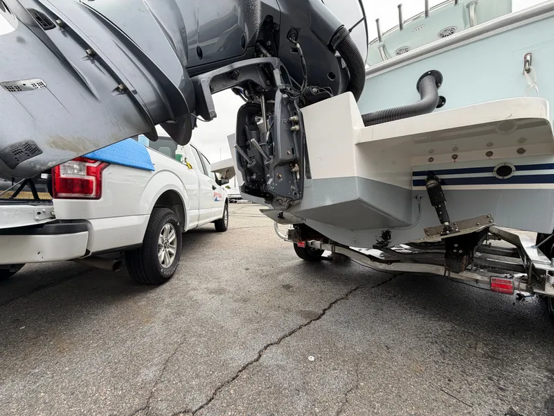 Slide: The Image of NorthCoast 230 CC 2022 boat on trailer beside white truck. - 20
