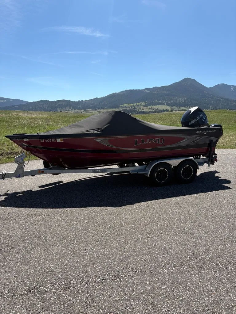 Slide: The Image of 2017 Lund 1875 Crossover XS boat on trailer with mountain backdrop. - 18