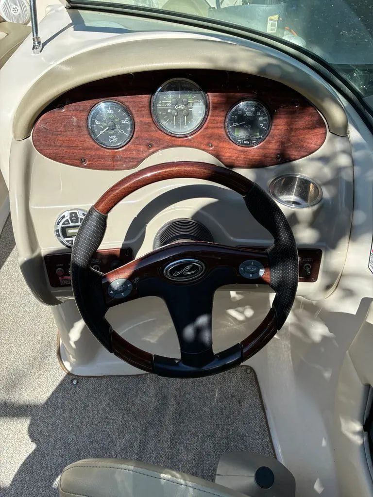 Slide: The Image of Steering wheel and dashboard of a 2005 Sea Ray 200 Sundeck boat. - 3