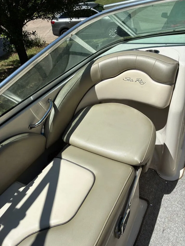 Slide: The Image of Interior of a 2005 Sea Ray 200 Sundeck boat with beige upholstery. - 4