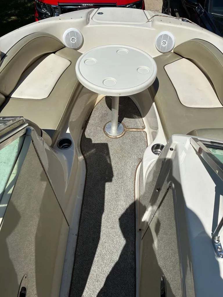 Slide: The Image of Interior of a 2005 Sea Ray 200 Sundeck with table and seating. - 8