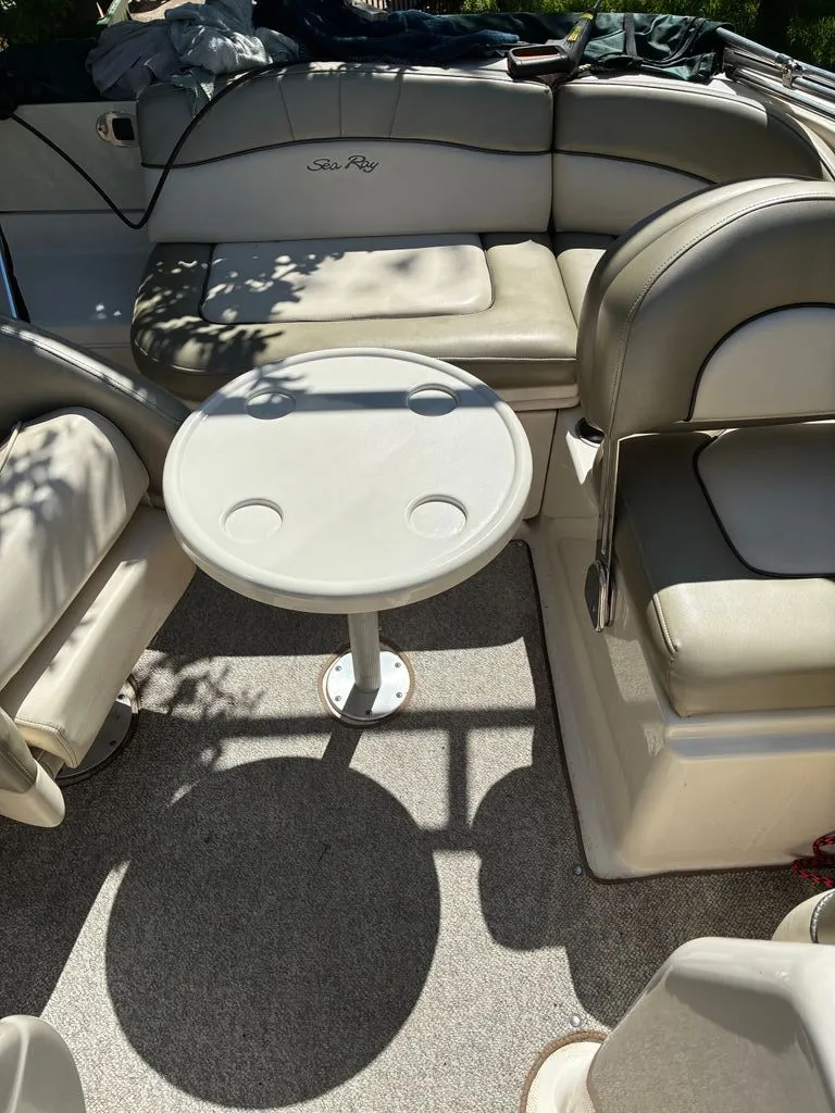 Slide: The Image of Interior of a 2005 Sea Ray 200 Sundeck with table and seating. - 9