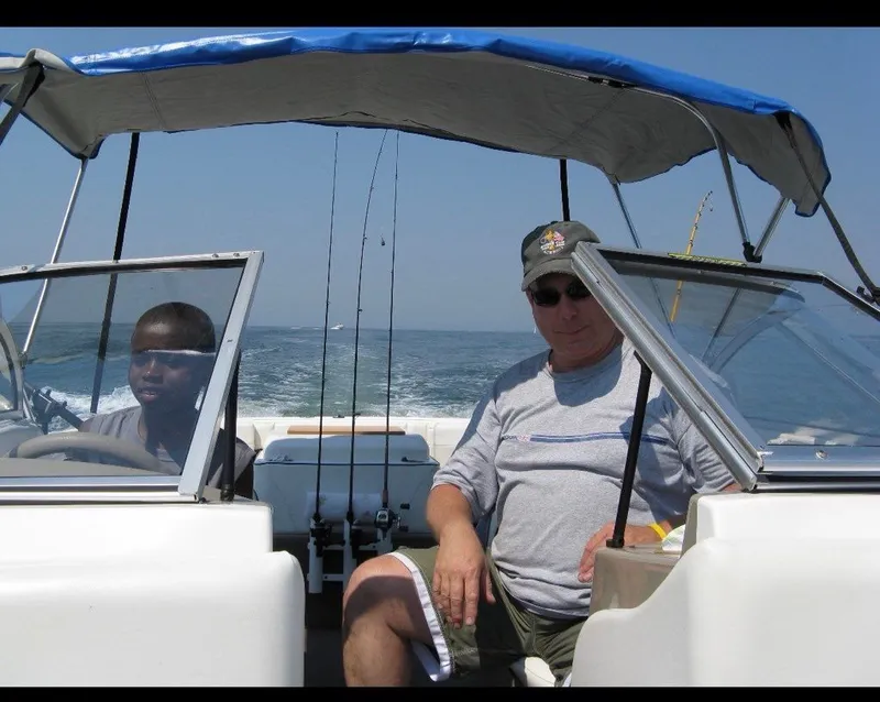Slide: The Image of Two people on a 2003 Bayliner 195 Bowrider boat on the water. - 9