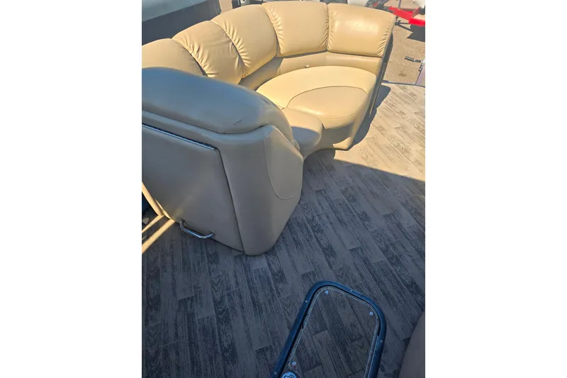 Slide: The Image of Luxurious seating on 2018 Manitou 23 Encore SL pontoon boat with wood-style flooring. - 6