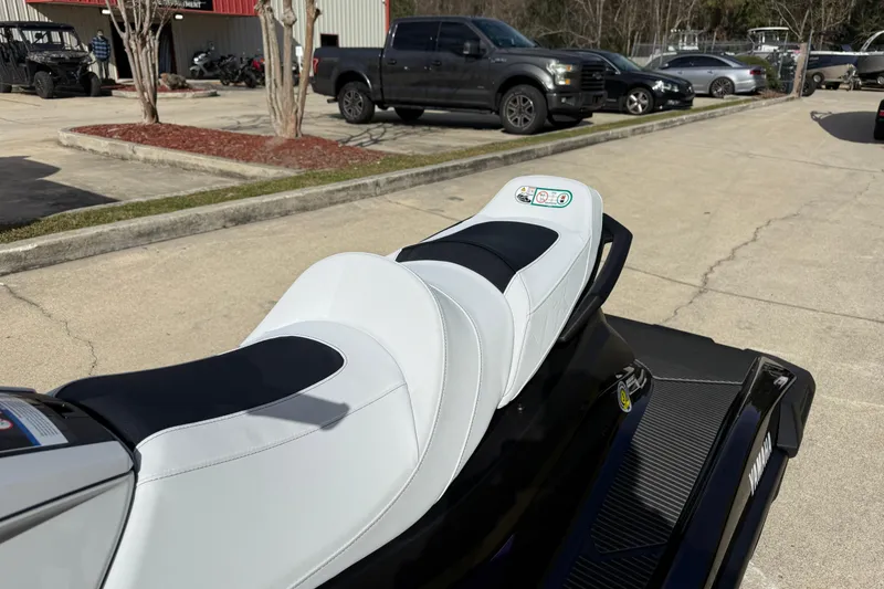 Slide: The Image of 2026 Yamaha WaveRunner VX Cruiser HO with sleek white and black seating, parked outdoors. - 14