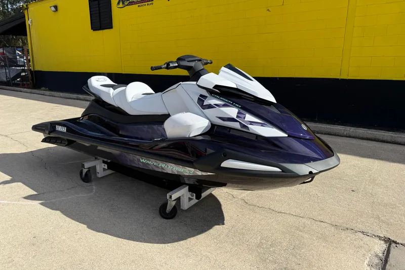 Slide: The Image of 2026 Yamaha WaveRunner VX Cruiser HO parked on concrete near a yellow building. - 4