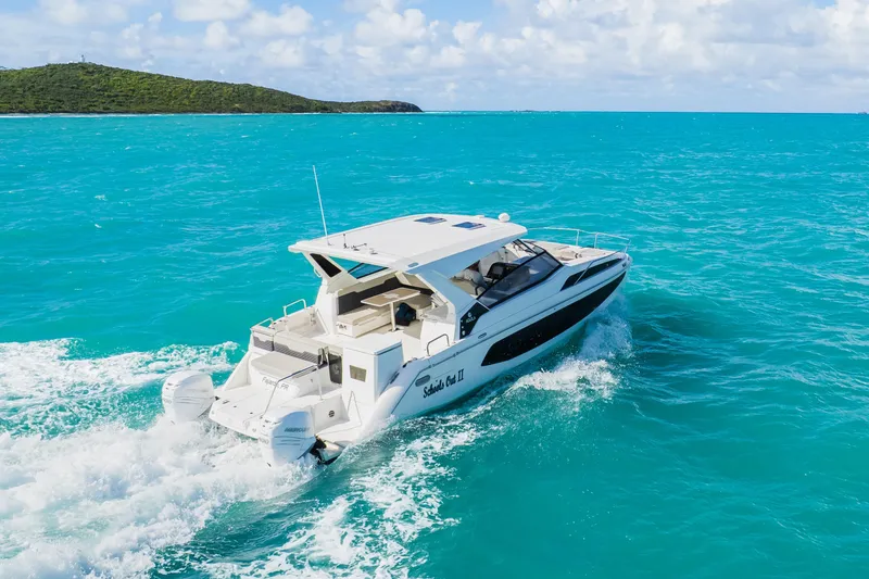 Slide: The Image of 2023 Aquila 36 Sport cruising on turquoise ocean waters. - 10