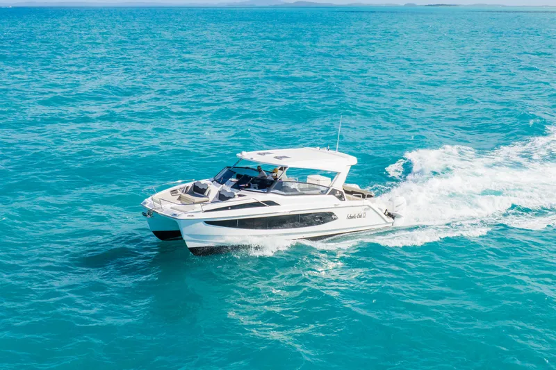 Slide: The Image of 2023 Aquila 36 Sport cruising on clear blue ocean waters. - 11