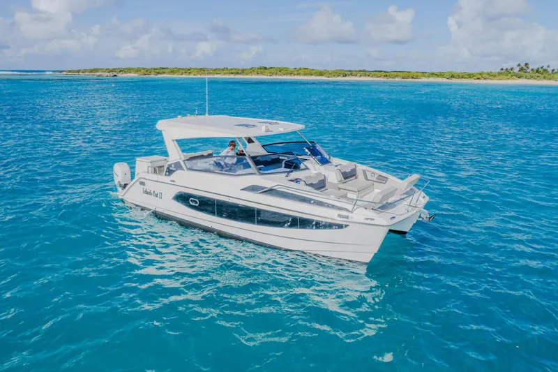 Slide: The Image of 2023 Aquila 36 Sport yacht cruising on clear blue ocean waters. - 2
