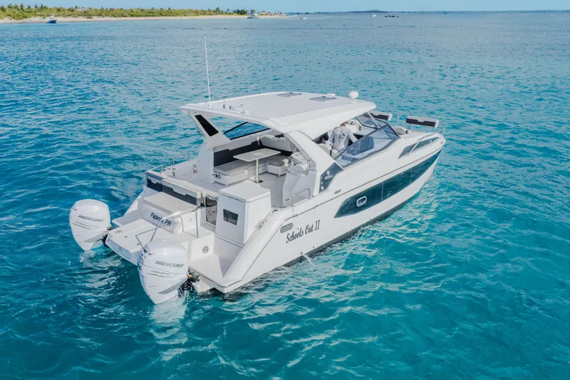 Slide: The Image of 2023 Aquila 36 Sport yacht cruising on clear blue ocean waters. - 4