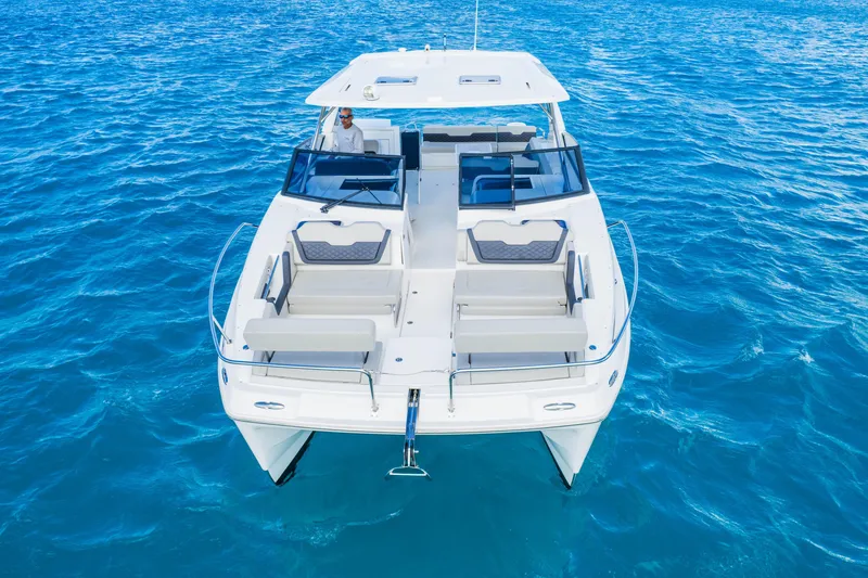 Slide: The Image of 2023 Aquila 36 Sport catamaran cruising on clear blue ocean waters. - 5