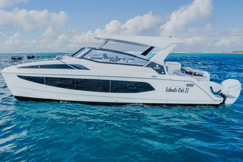 Slide: The Image of 2023 Aquila 36 Sport yacht cruising on clear blue ocean waters. - 6