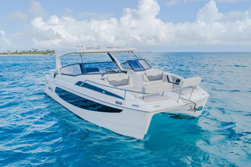 Slide: The Image of 2023 Aquila 36 Sport boat cruising on clear blue ocean waters. - 7