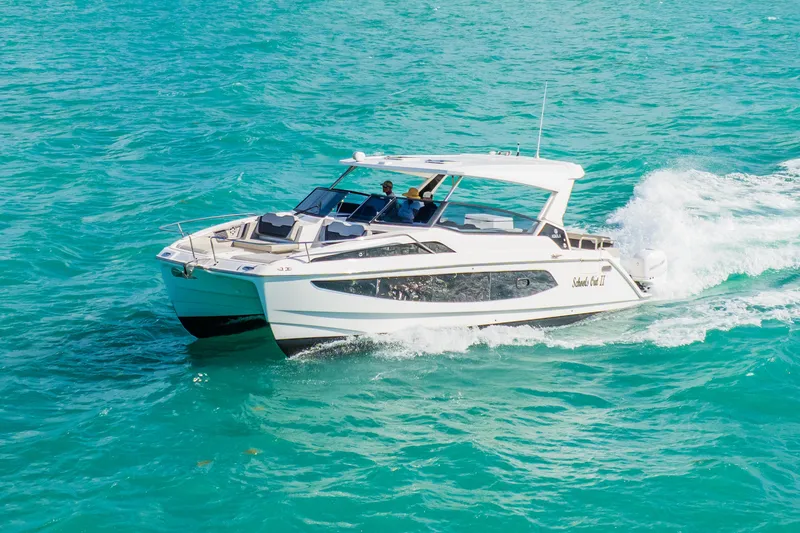 Slide: The Image of 2023 Aquila 36 Sport cruising on turquoise waters. - 9