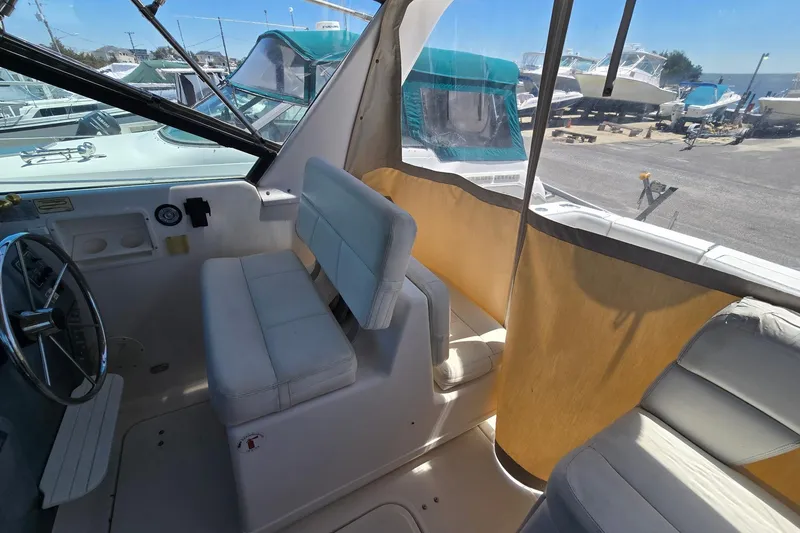 Slide: The Image of Interior view of a 1999 Tiara Yachts 3100 Open, featuring helm and seating area. - 12