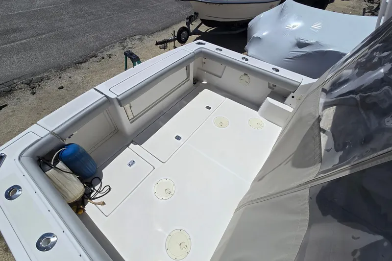 Slide: The Image of 1999 Tiara Yachts 3100 Open boat deck with storage compartments and seating. - 8