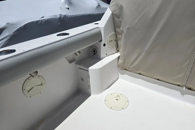 Slide: The Image of 1999 Tiara Yachts 3100 Open cockpit detail with storage compartments and covered seating area. - 9