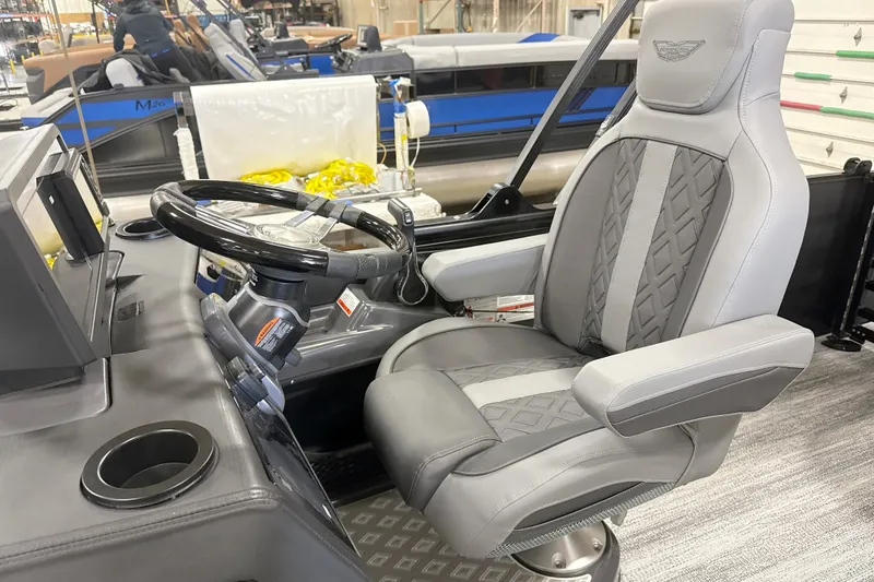 Slide: The Image of Captain's chair and helm of 2026 Bennington 22 M Swingback boat, featuring modern design. - 13
