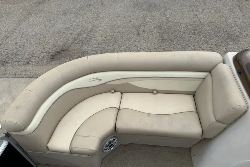 Slide: The Image of 2015 Bennington 18 SLX boat with beige cushioned seating and speaker detail. - 10
