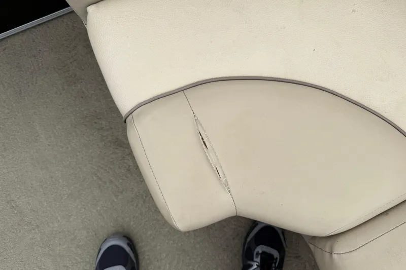 Slide: The Image of Torn upholstery on 2015 Bennington 18 SLX boat seat, showing wear and damage. - 12