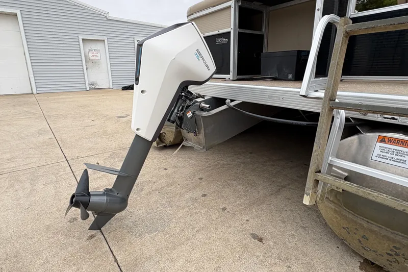 Slide: The Image of 2015 Bennington 18 SLX pontoon boat with electric outboard motor on concrete surface. - 4