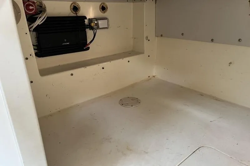 Slide: The Image of Interior view of a 1995 Mako 293 Walk Around boat compartment with wiring and equipment. - 8