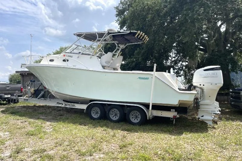 Slide: The Image of 1995 Mako 293 Walk Around boat on trailer with Suzuki outboard motor. - 1