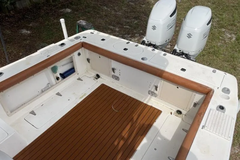 Slide: The Image of 1995 Mako 293 Walk Around boat deck with twin Suzuki outboard motors. - 11