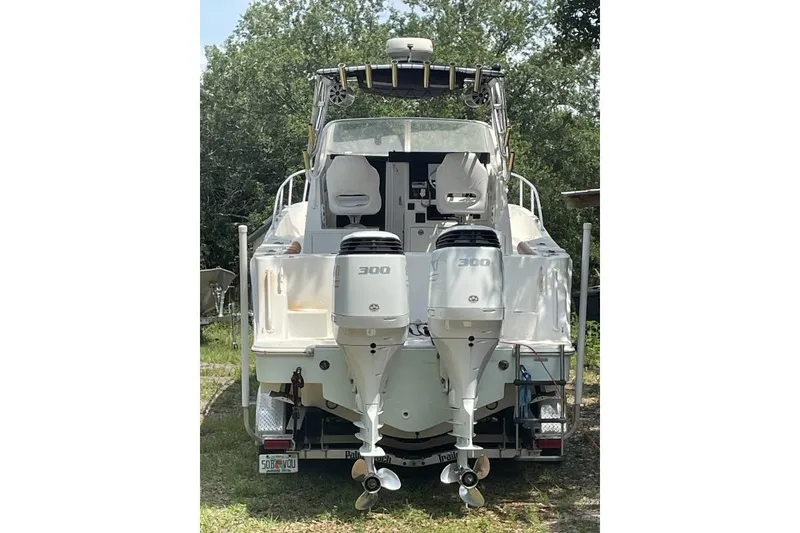 Slide: The Image of 1995 Mako 293 Walk Around boat with dual 300 horsepower engines, rear view. - 3