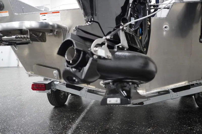Slide: The Image of Rear view of 2026 Thunder Jet 209 Rush OT boat on trailer, showcasing engine and hull. - 17