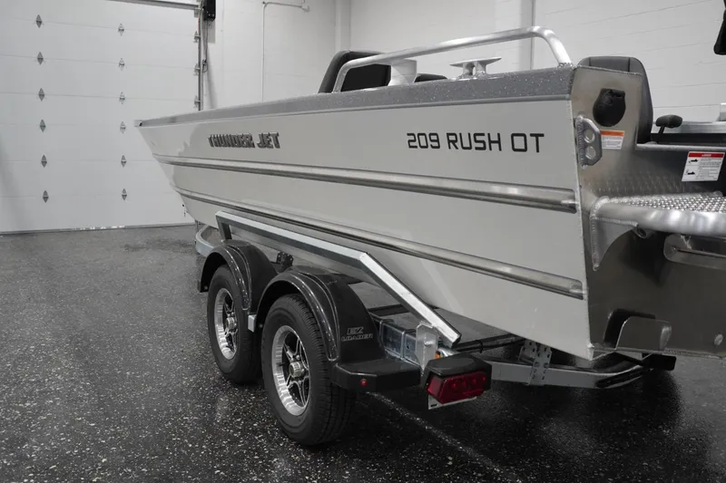 Slide: The Image of 2026 Thunder Jet 209 Rush OT boat on trailer in indoor garage setting. - 21
