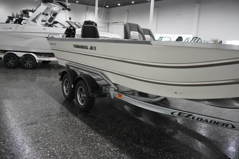 Slide: The Image of 2026 Thunder Jet 209 Rush OT boat on EZ Loader trailer in showroom. - 6