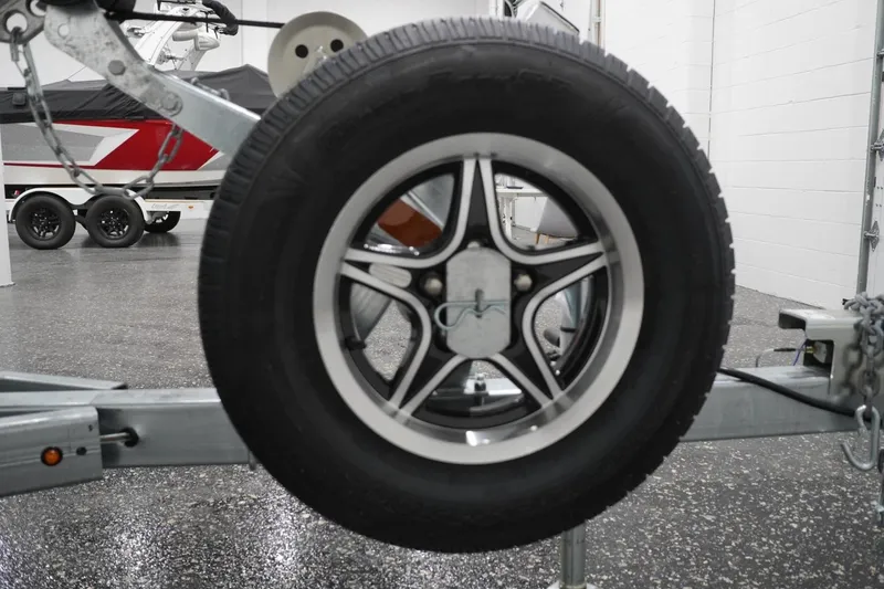 Slide: The Image of Trailer wheel of 2026 Thunder Jet 209 Rush OT boat in showroom. - 7