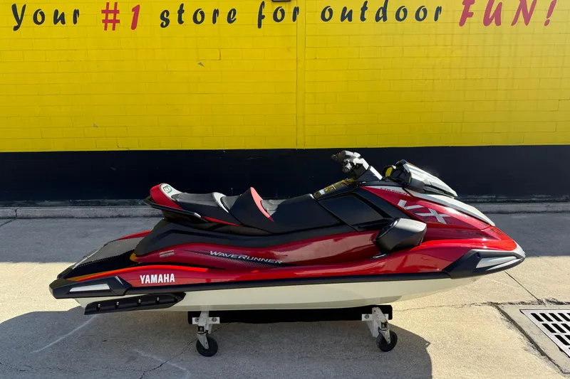 The Image of 2026 Yamaha WaveRunner VX Cruiser in red, parked against a vibrant yellow wall. - 1