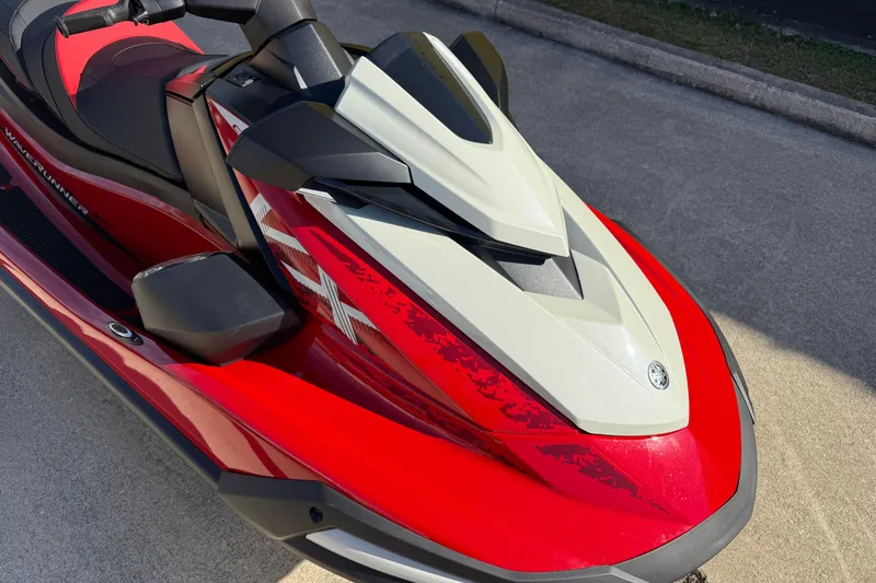 Slide: The Image of 2026 Yamaha WaveRunner VX Cruiser in red and white, parked on concrete surface. - 12