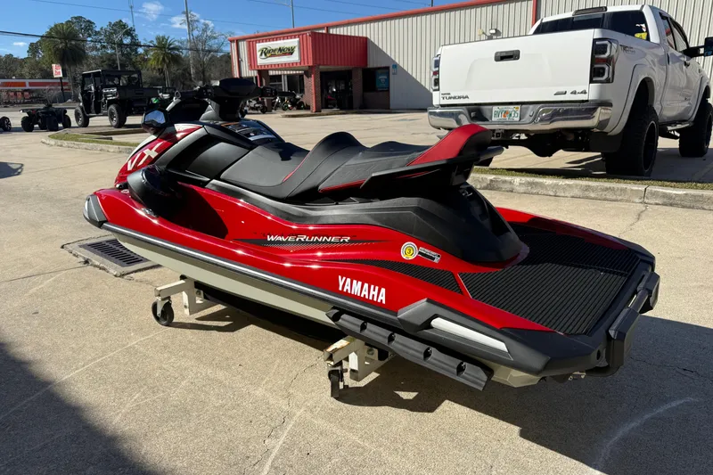 Slide: The Image of 2026 Yamaha WaveRunner VX Cruiser in red, parked outdoors near a dealership. - 8