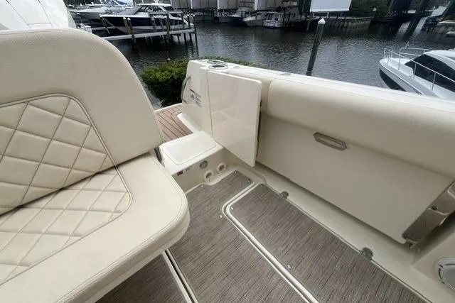Slide: The Image of 2024 Chris-Craft Catalina 30 boat interior with beige seating and waterfront view. - 14