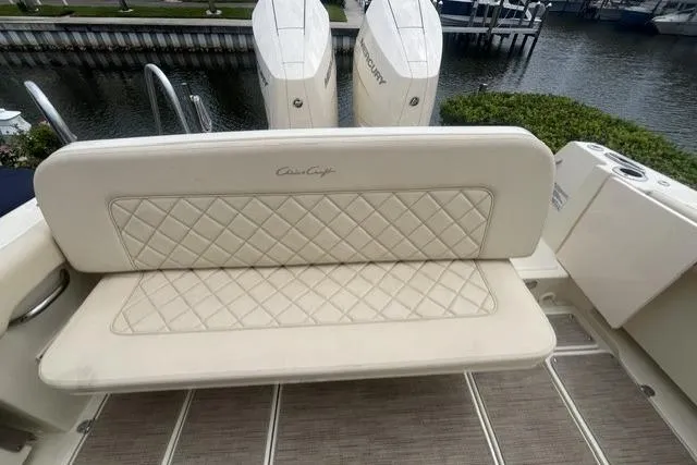 Slide: The Image of 2024 Chris-Craft Catalina 30 boat with cushioned seating and dual Mercury engines. - 16